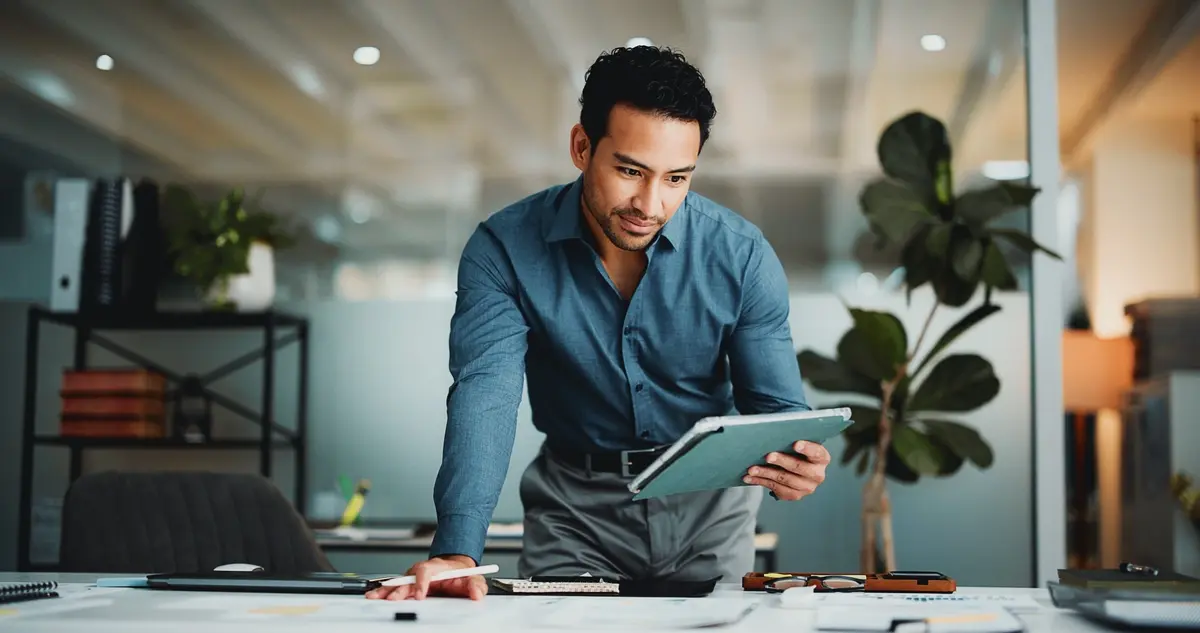 Accounting and finance professional reviewing data on a tablet