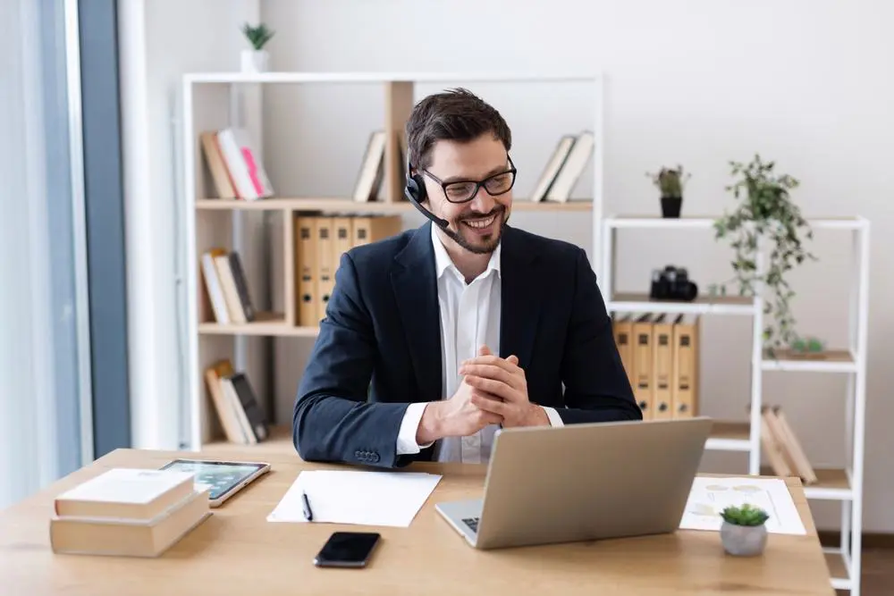 Customer experience and support professional working on a laptop